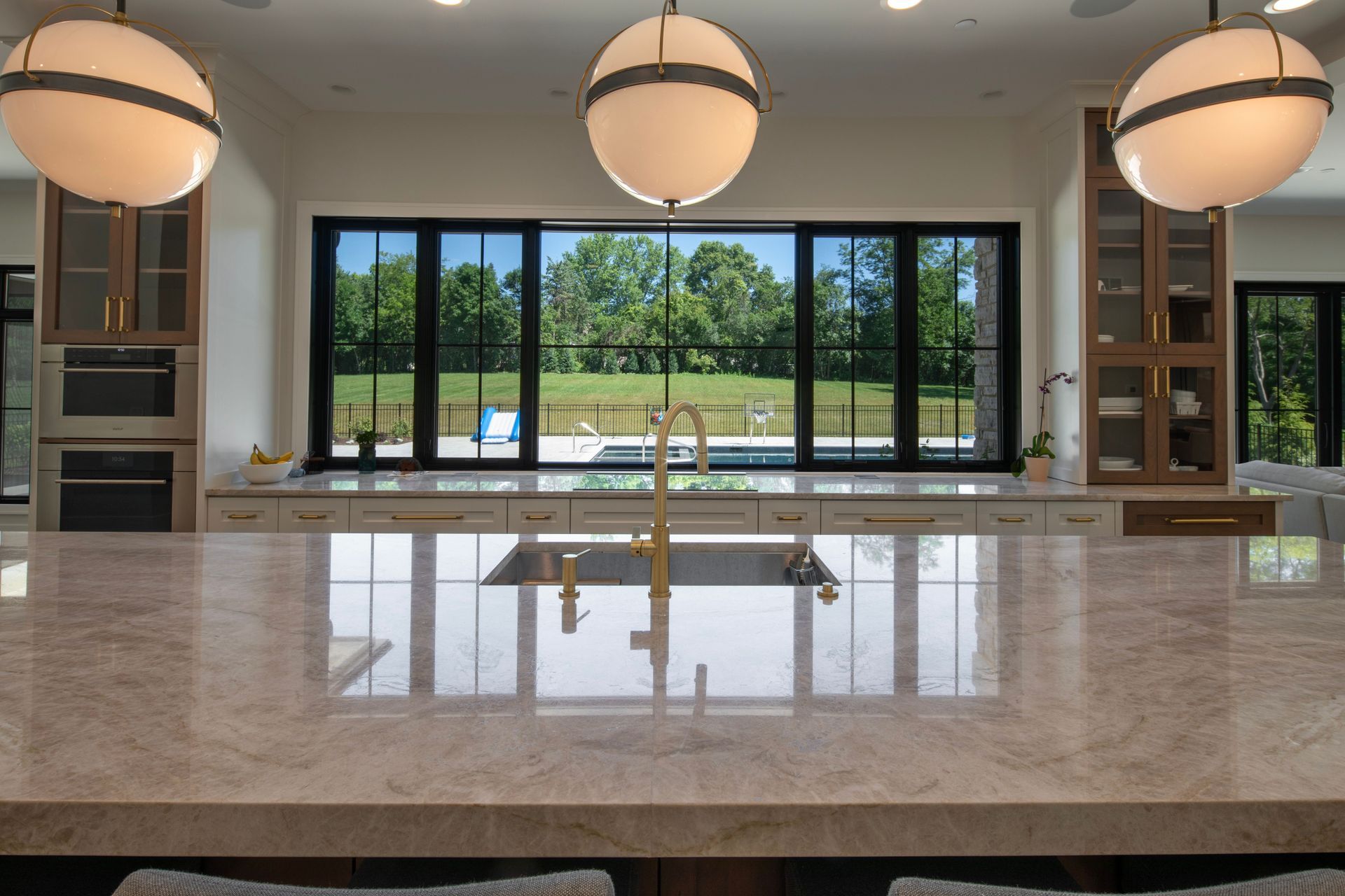 A kitchen with a sink and a large window