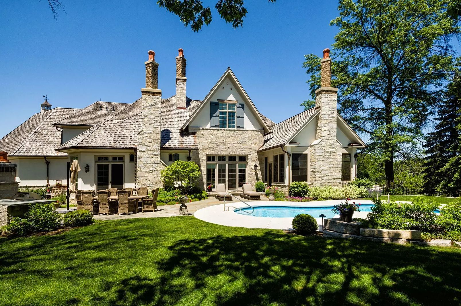 A large house with a swimming pool in the backyard.