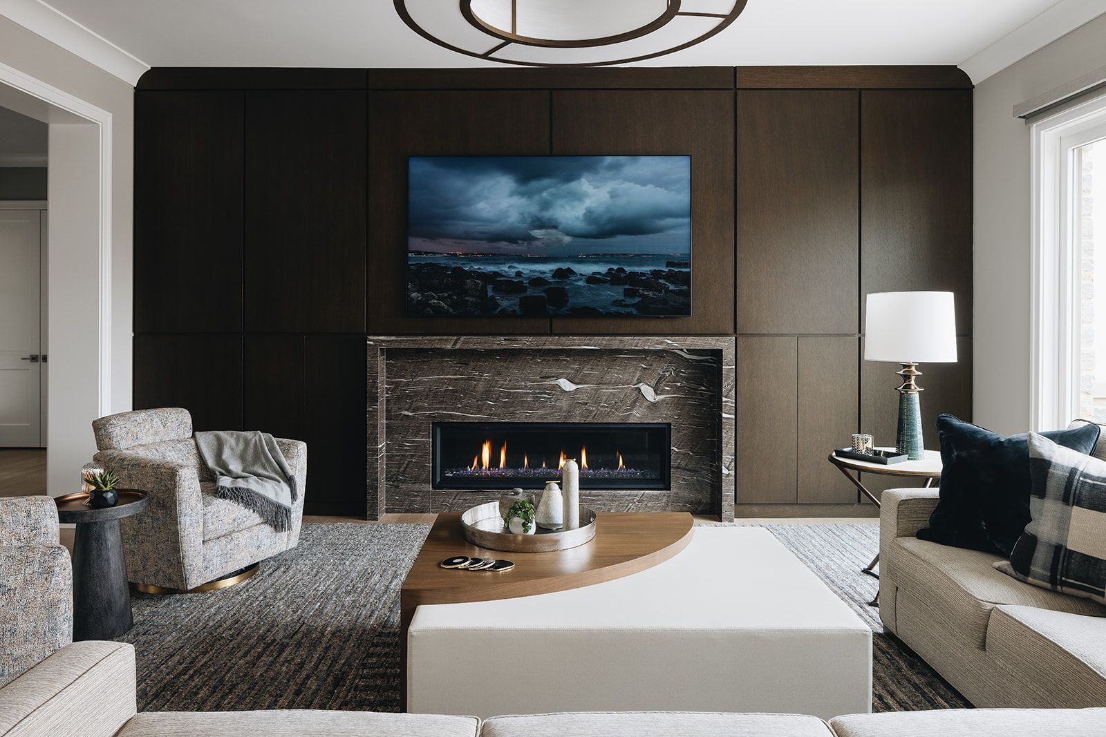 A living room with a fireplace and a flat screen tv on the wall.