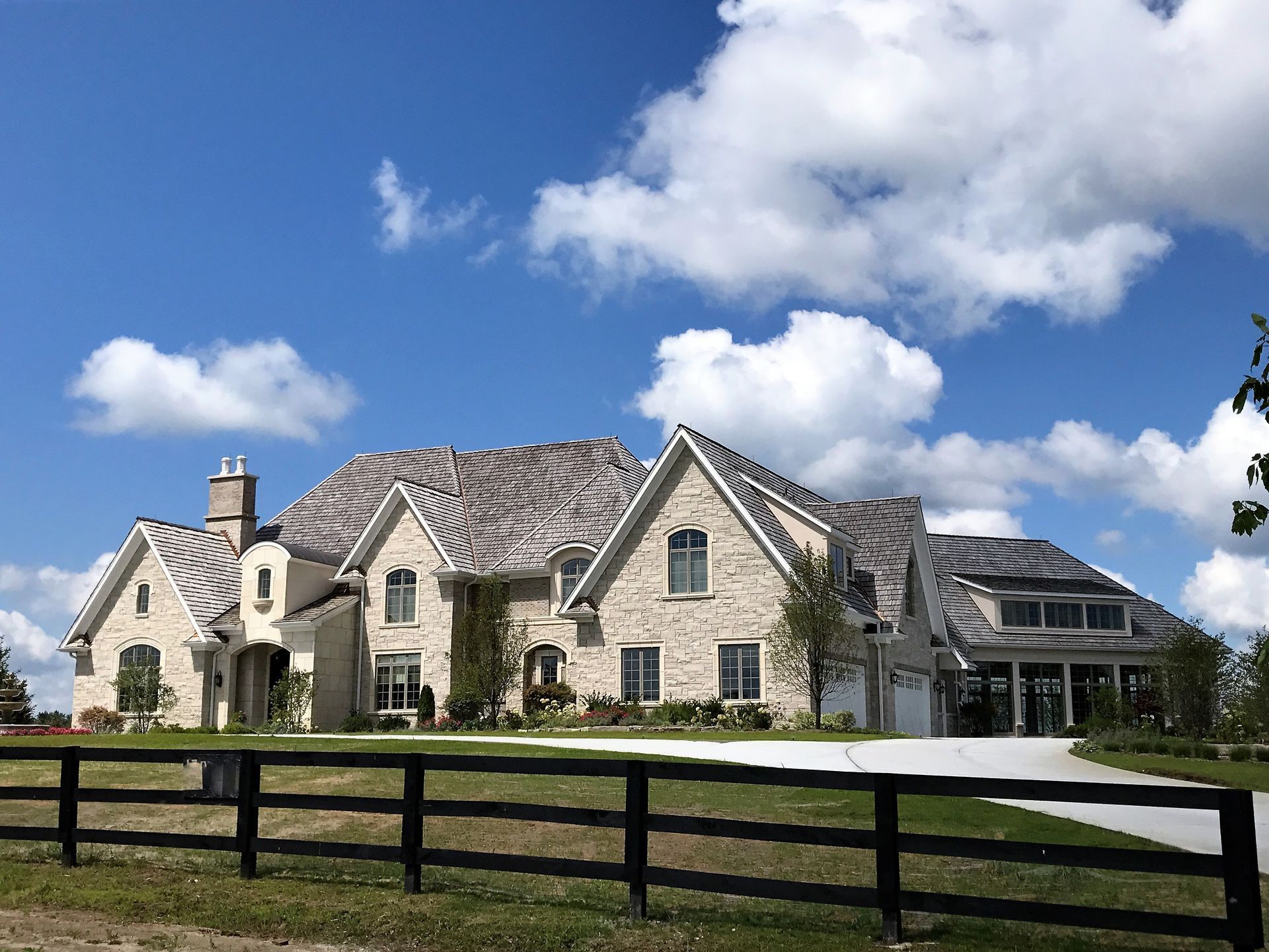 A large house with a black fence in front of it