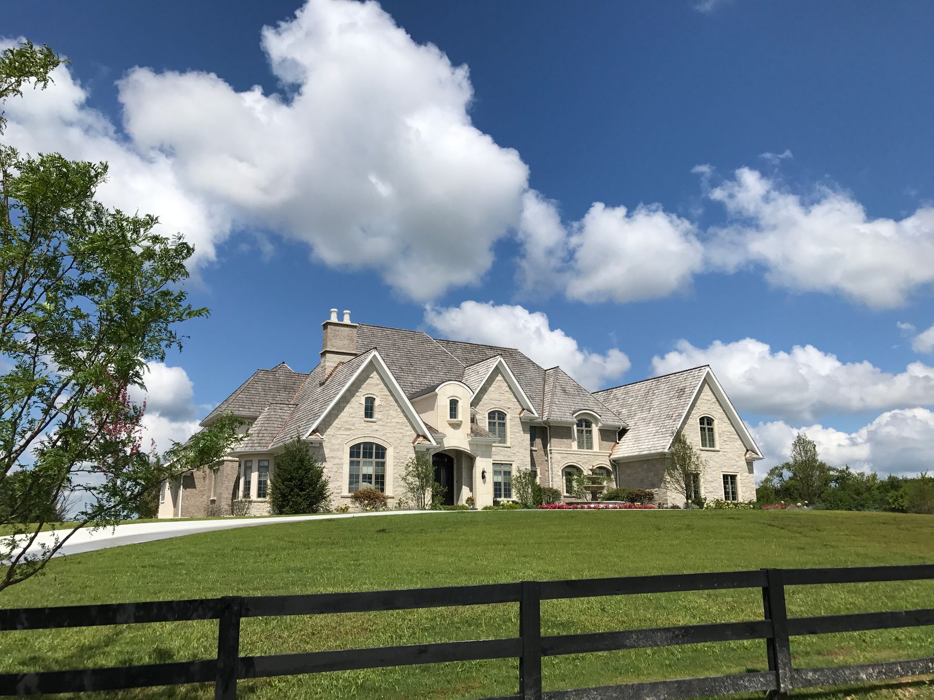 A large house with a black fence in front of it