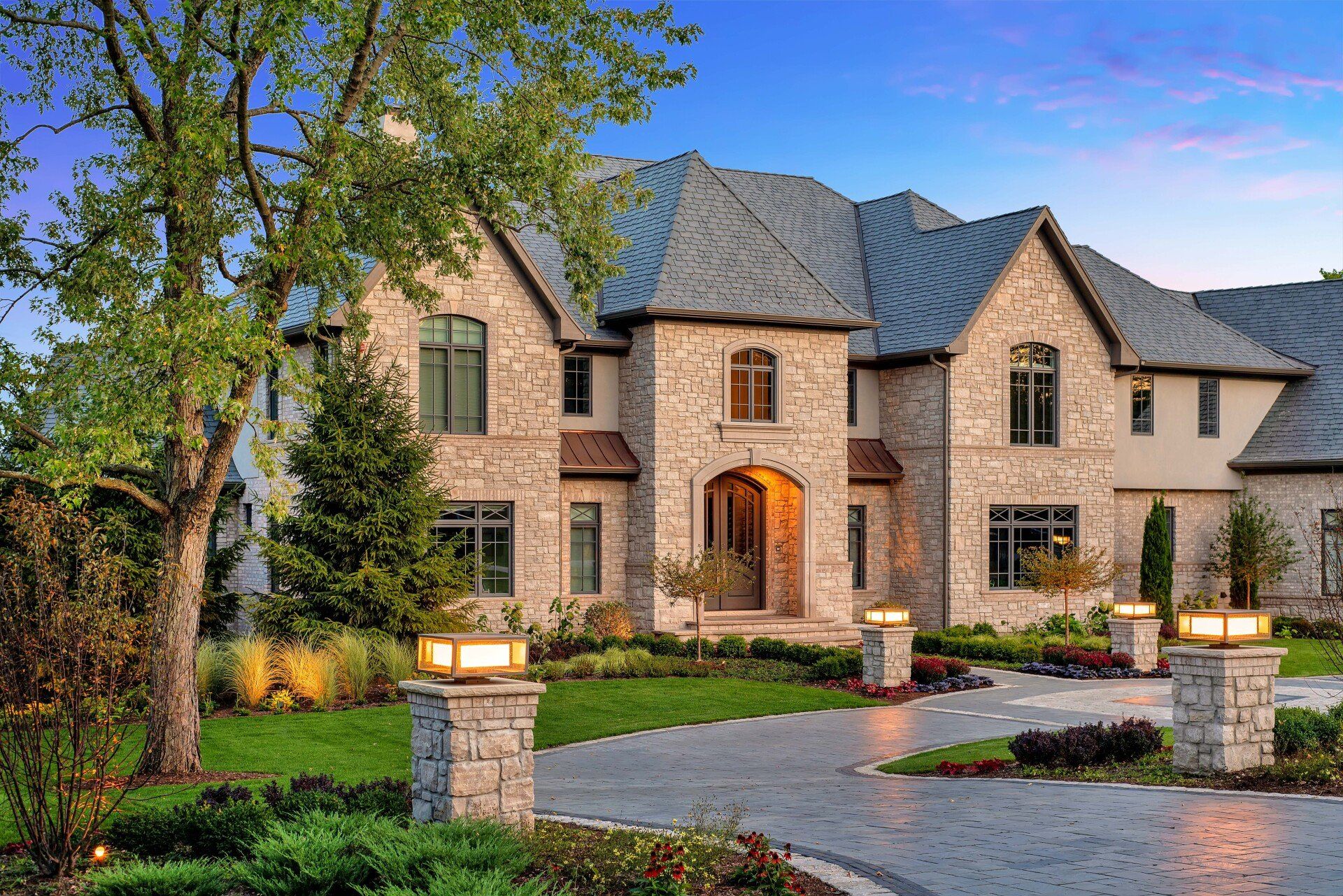A large brick house with a driveway leading to it