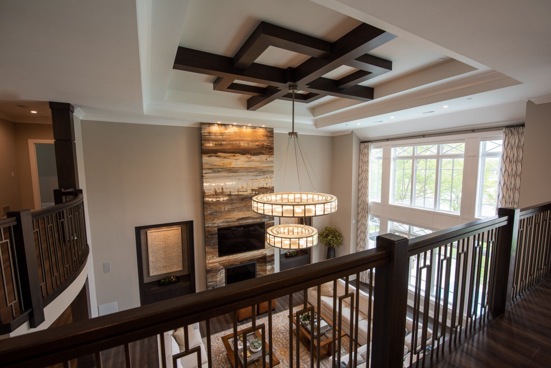 A view of a living room from the second floor of a house.