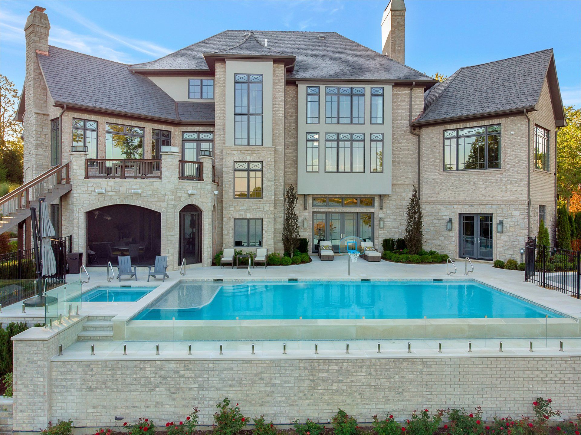 A large house with a large swimming pool in front of it.