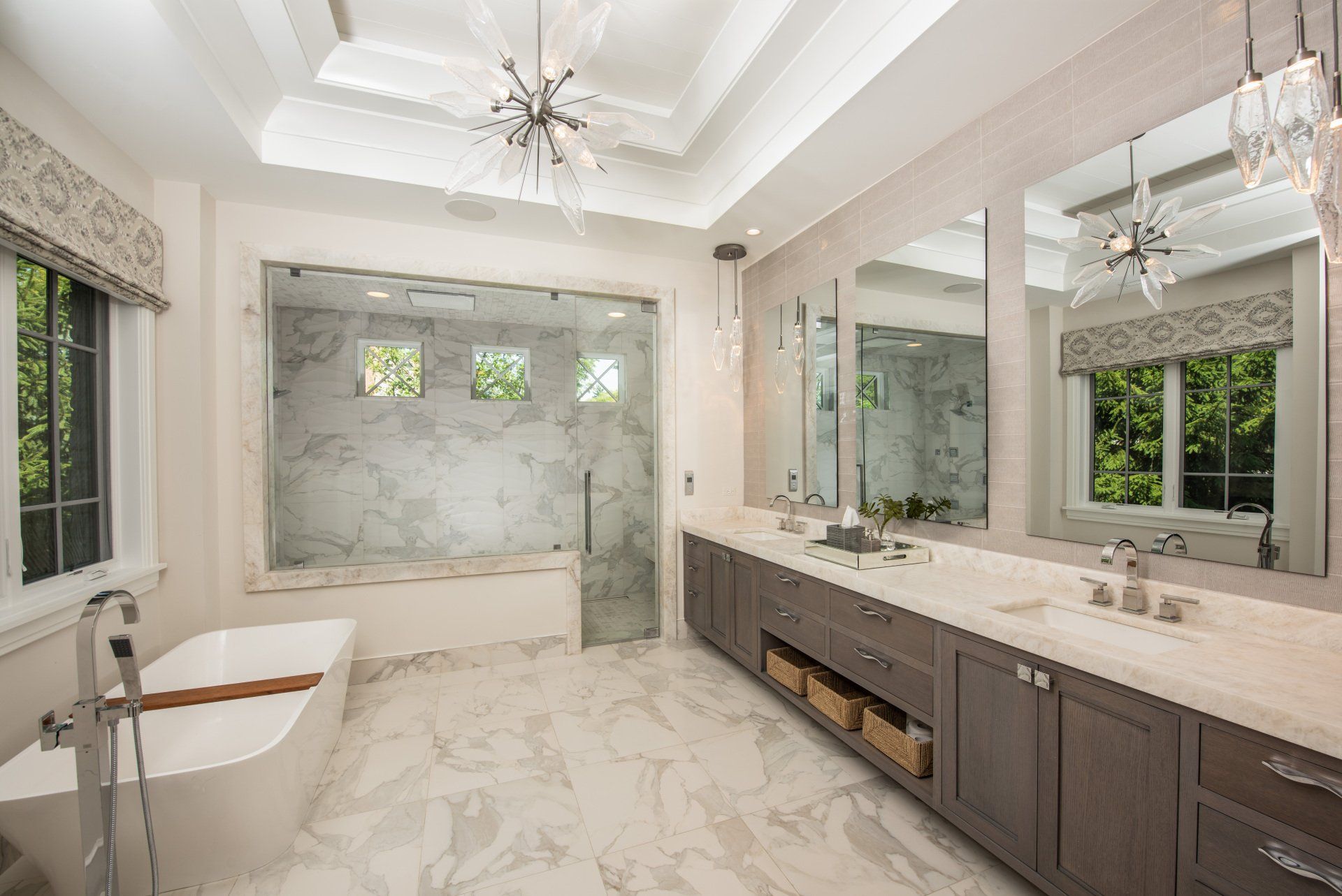 A bathroom with a bathtub , sinks , mirrors and a walk in shower.