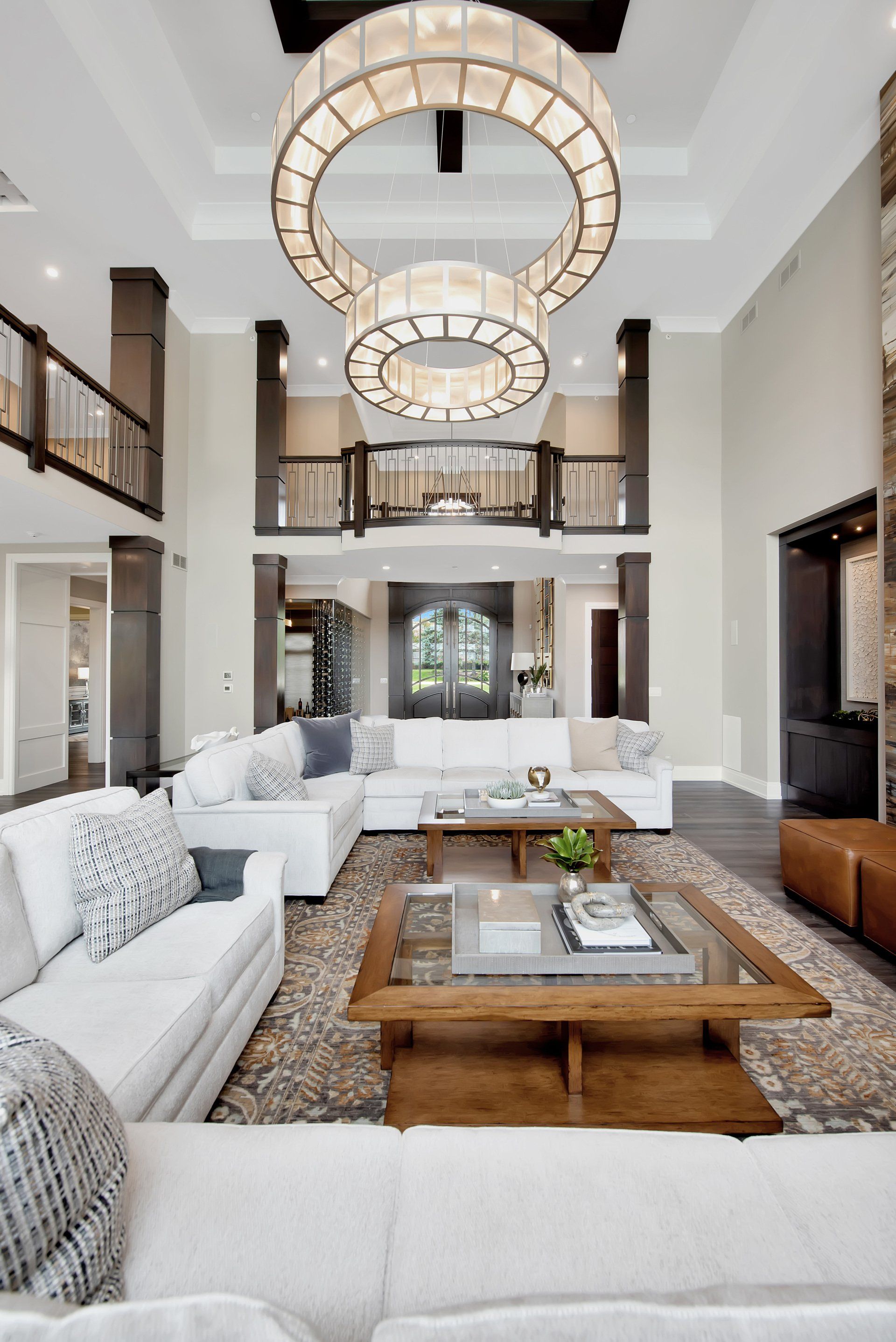 A living room with a lot of furniture and a chandelier hanging from the ceiling.