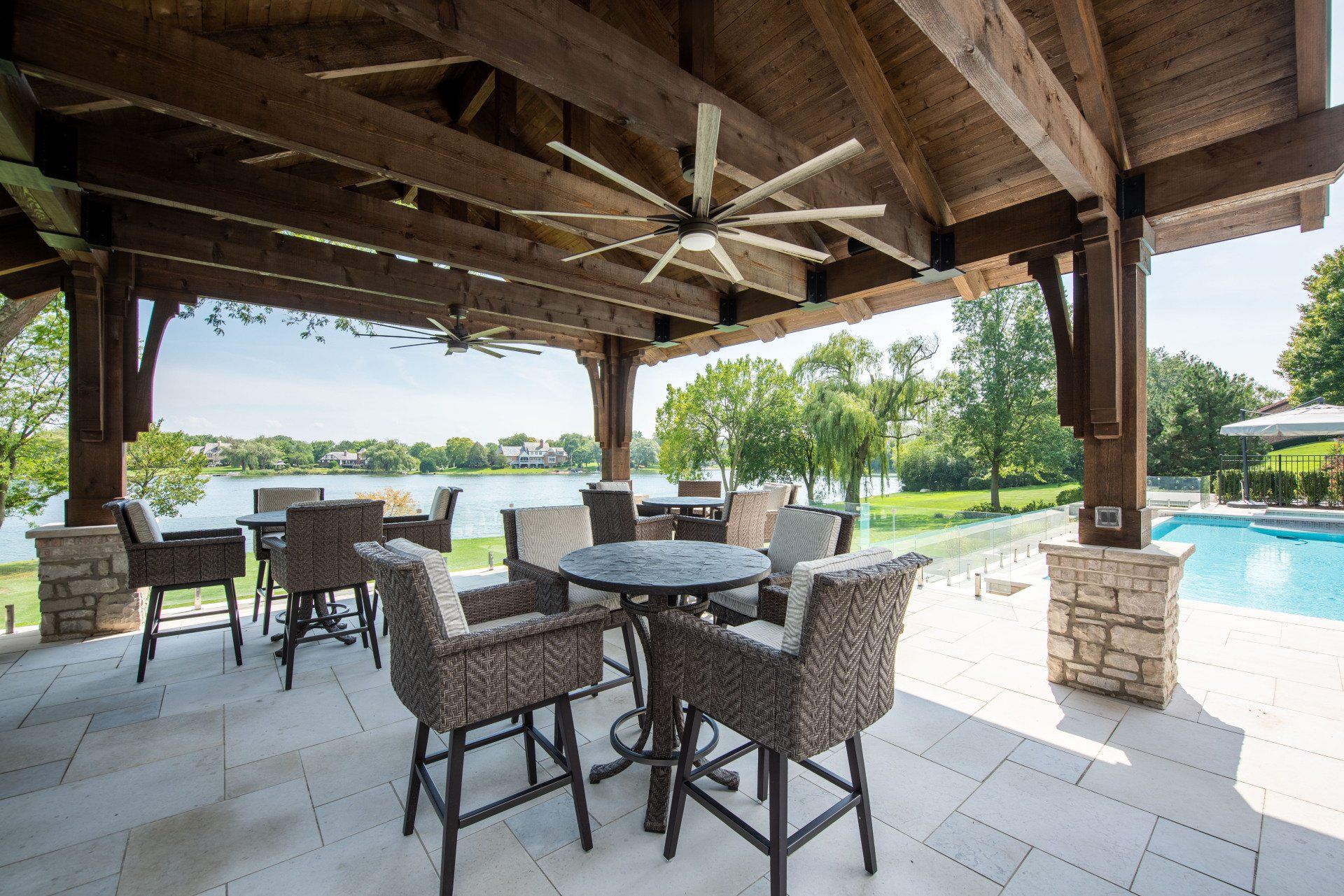 A patio with a table and chairs and a ceiling fan.