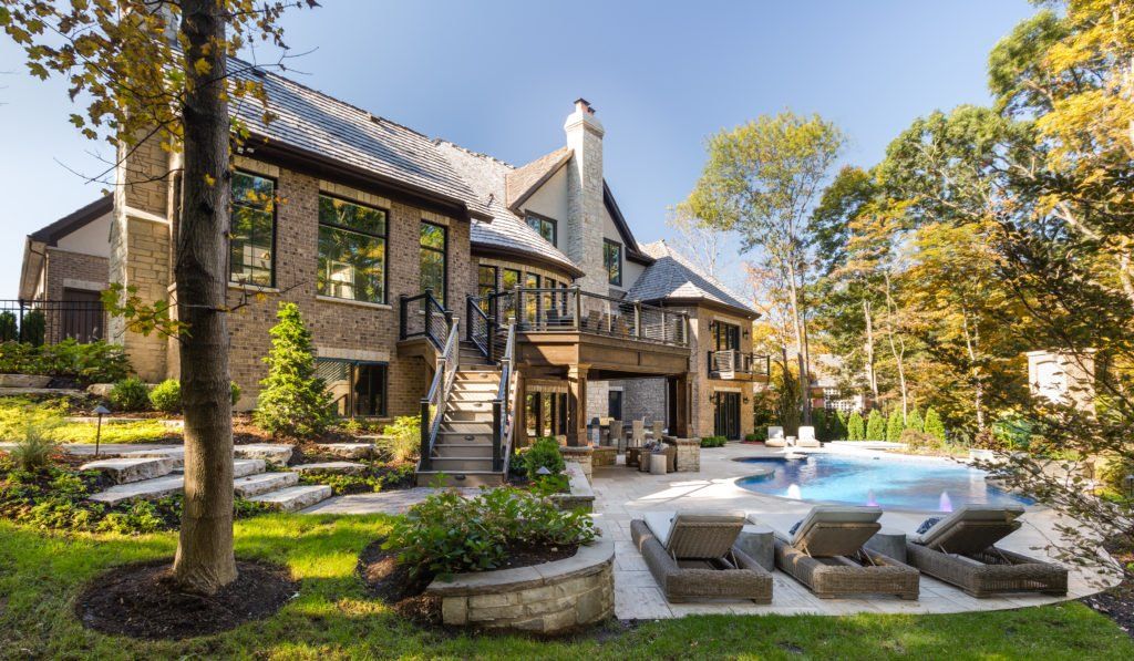 A large house with a large swimming pool in the backyard.
