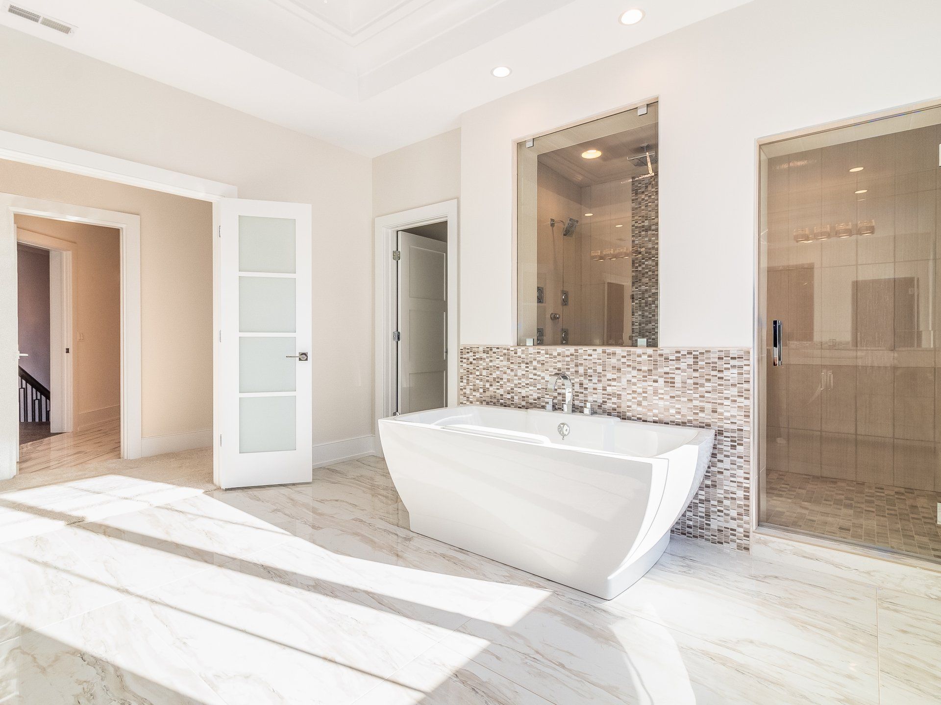 A bathroom with a bathtub and a walk in shower.
