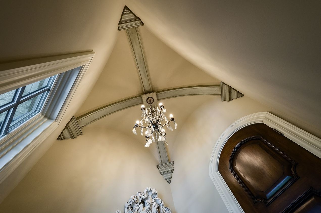 A chandelier is hanging from the ceiling of a room.