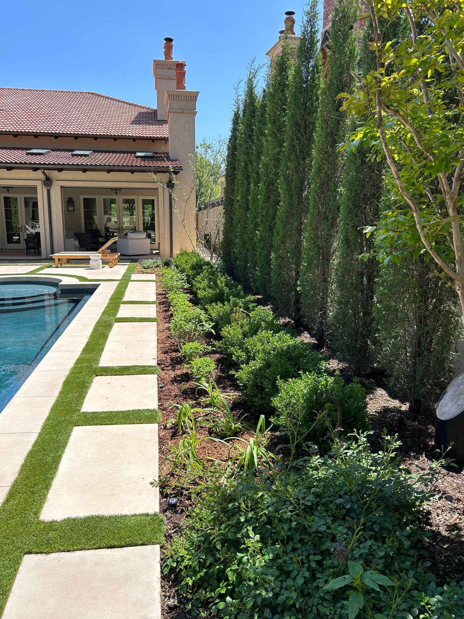 There is a swimming pool in the backyard of a house.