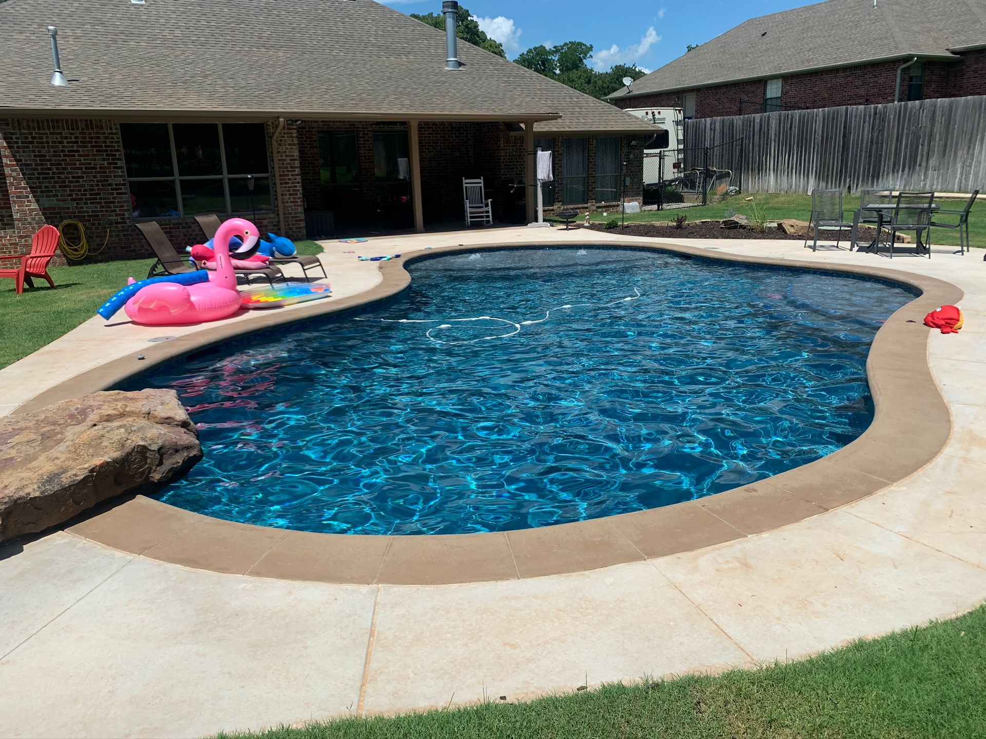 A large swimming pool in the backyard of a house