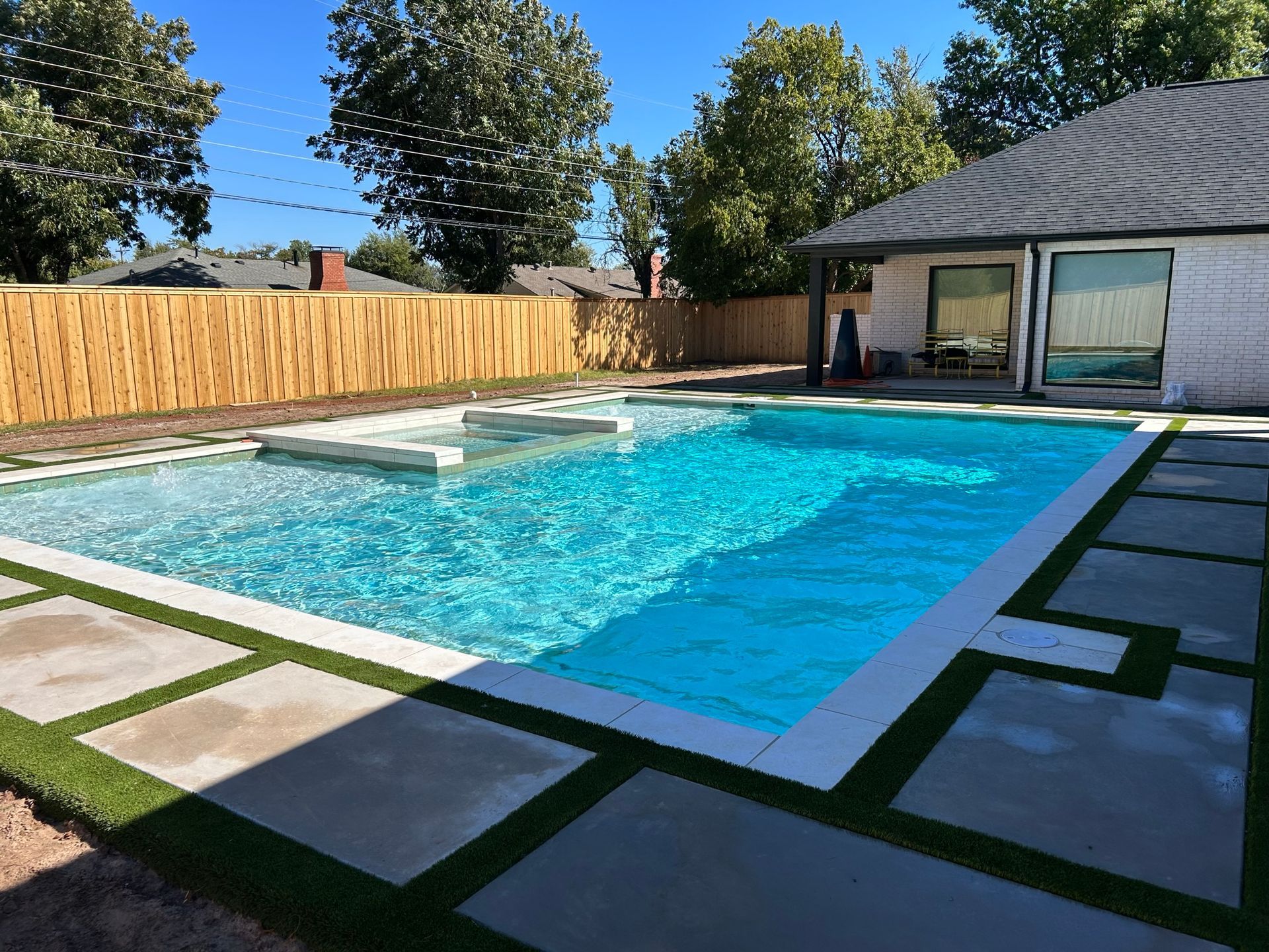 A large swimming pool in the backyard of a house
