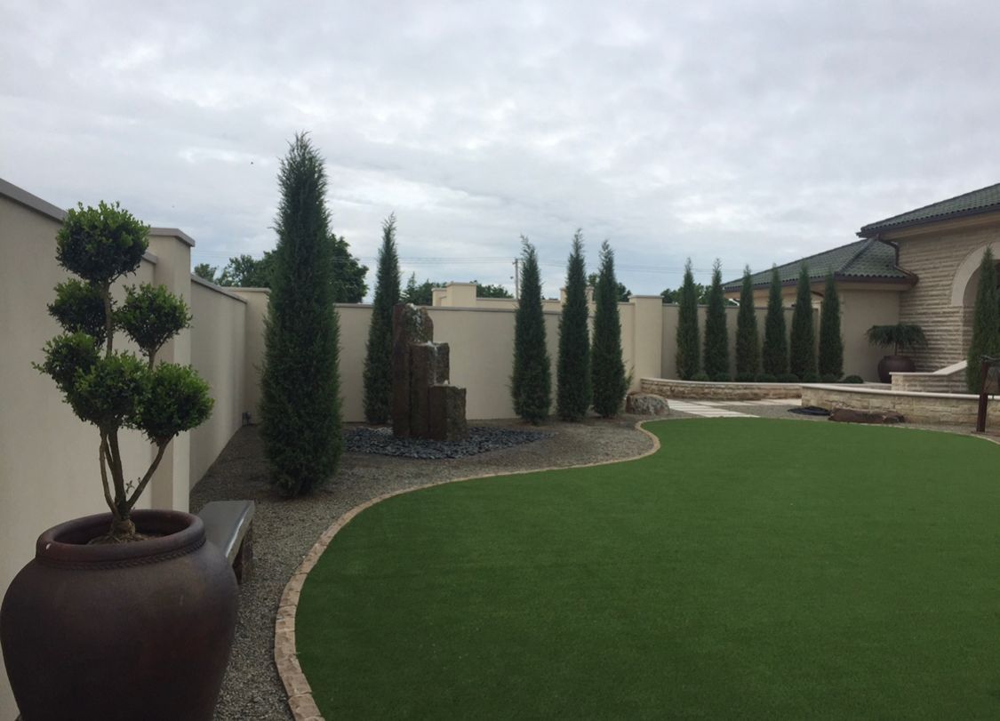A potted plant is sitting in the middle of a lush green lawn.