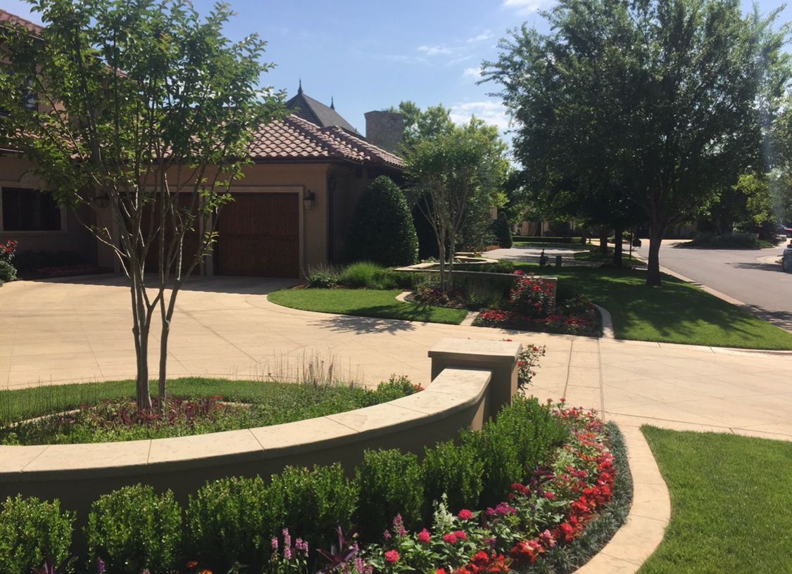 A house with a lot of flowers in front of it