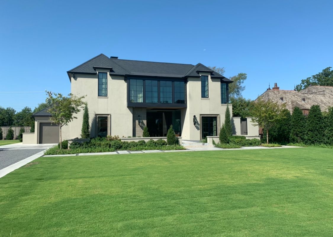 A large house with a lush green lawn in front of it.