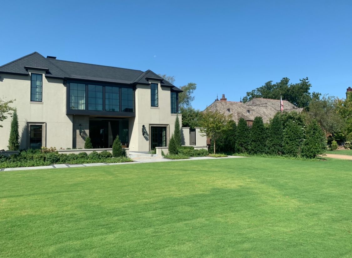 A large house with a large lawn in front of it.