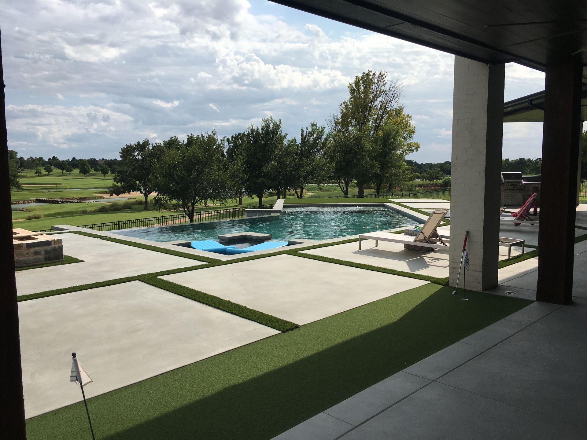 A view of a large swimming pool from a patio