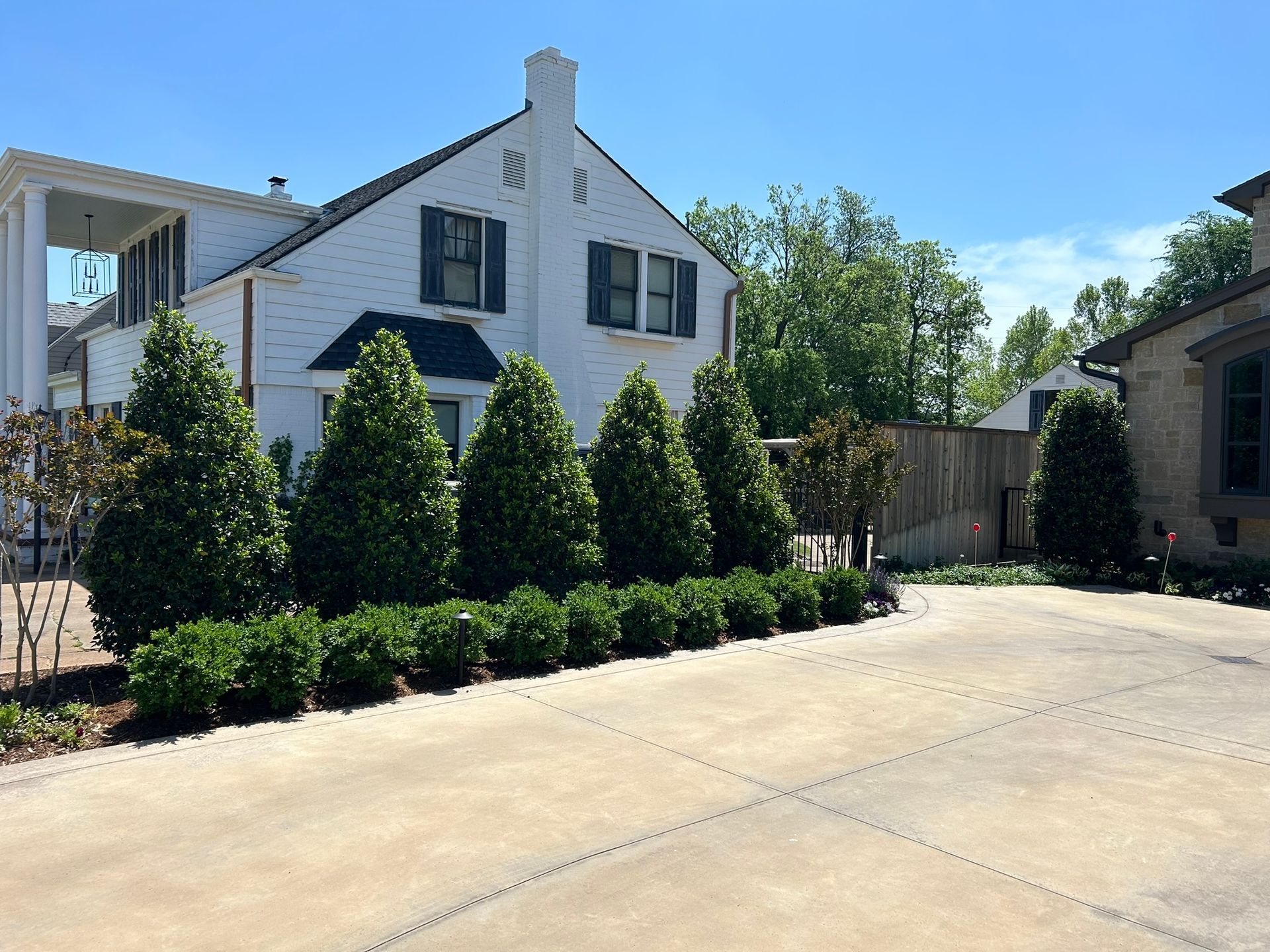 A large white house with a lot of trees in front of it