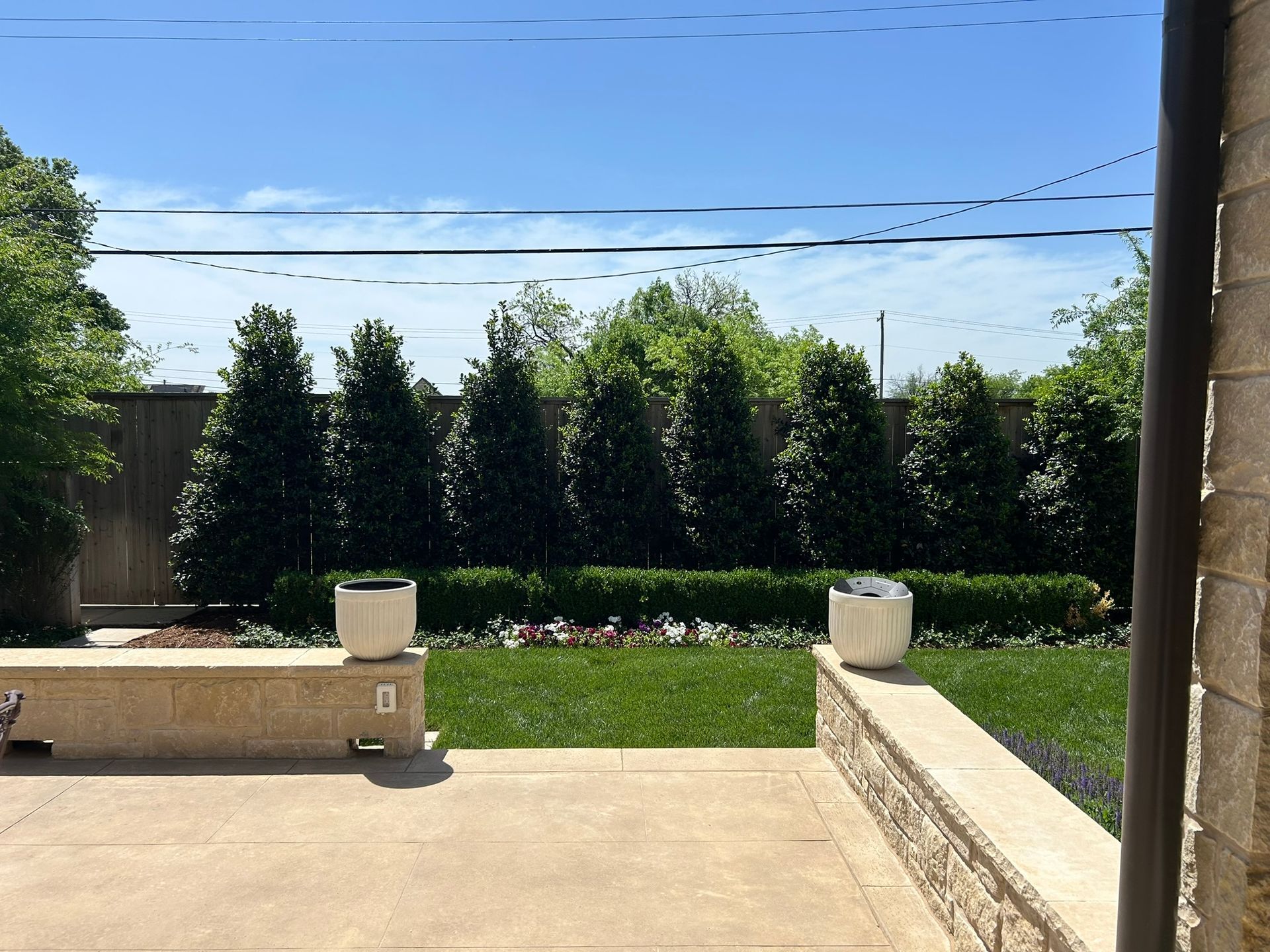 A patio with a few potted plants on it