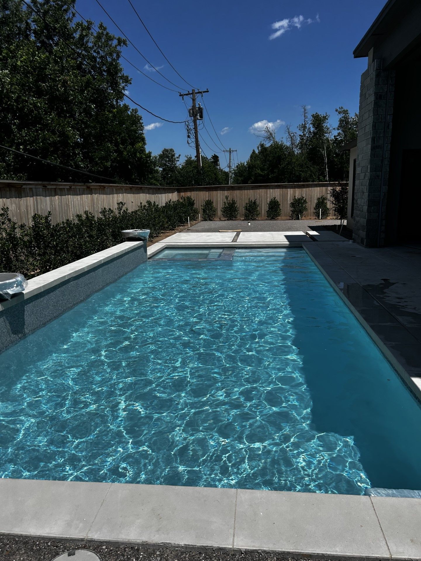 A large swimming pool with a blue sky in the background
