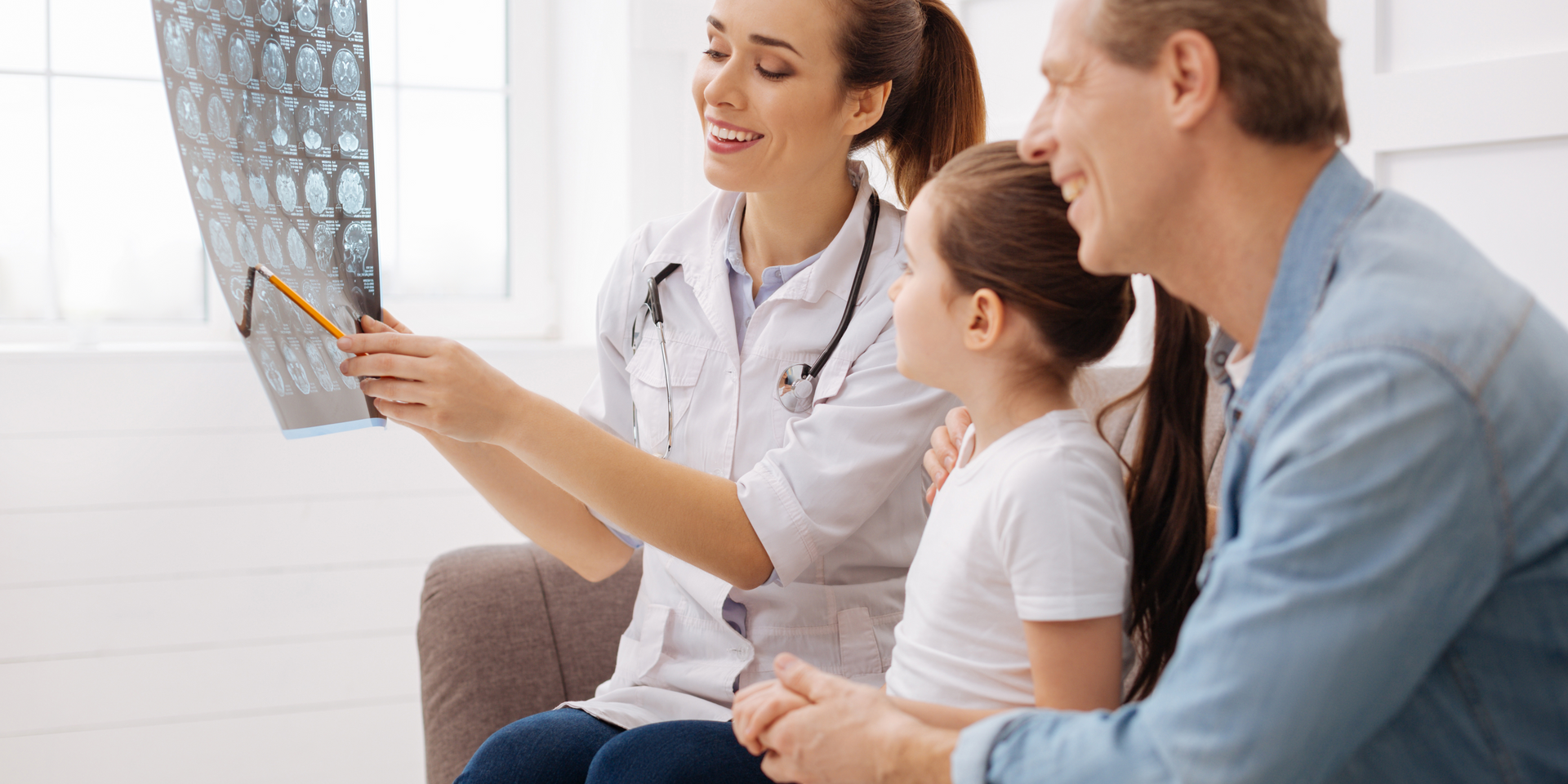 A doctor is looking at an x-ray with a family.