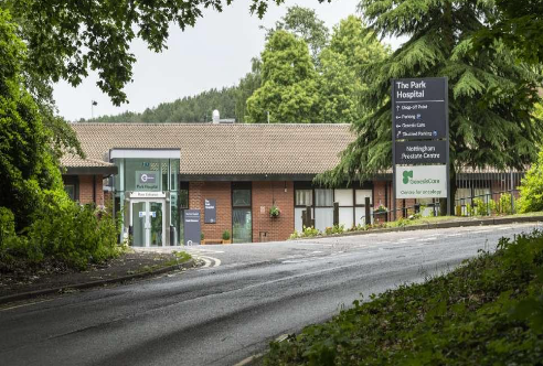 A large brick building with a sign in front of it.