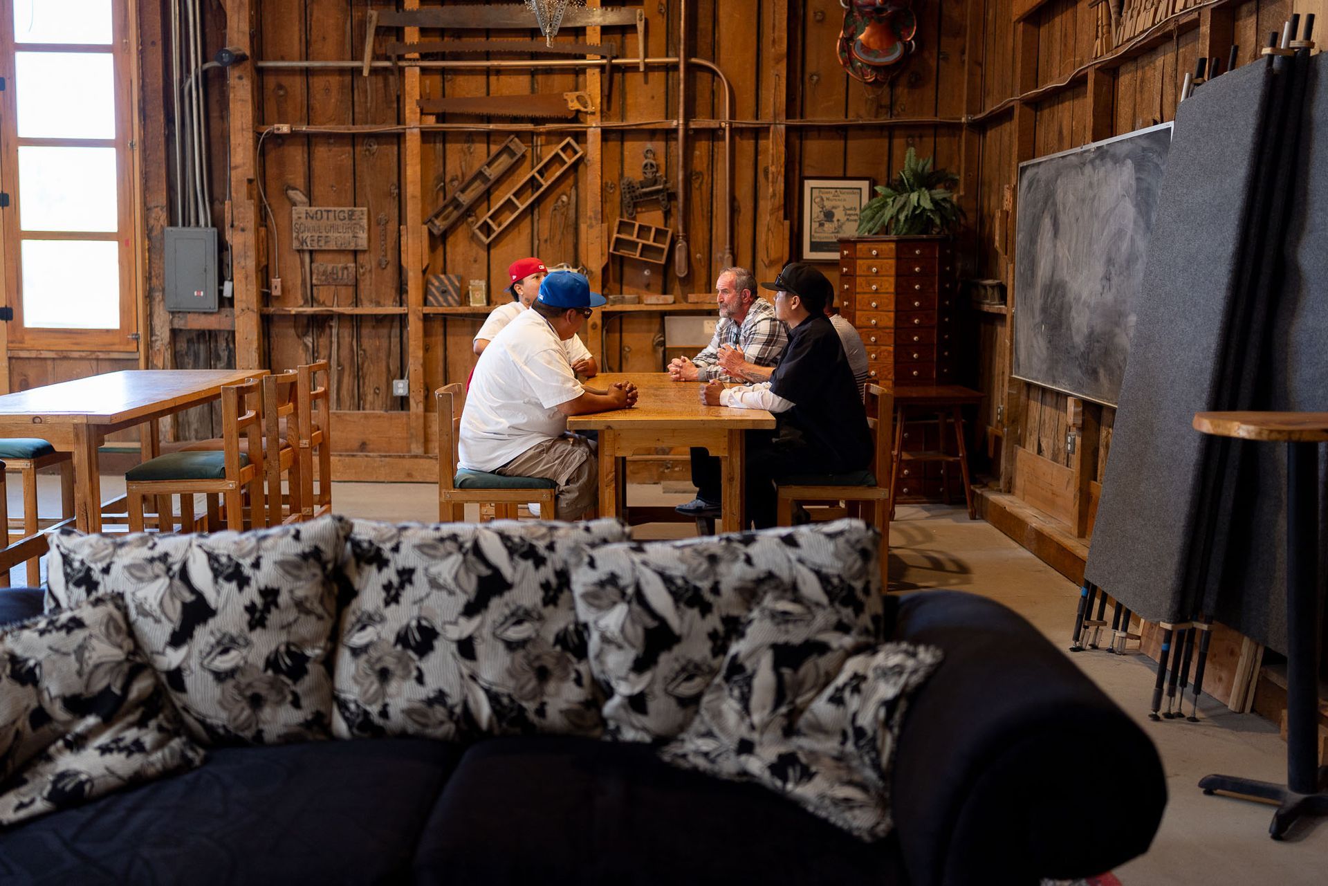 Man and woman in conversation on a couch; indoor setting. Man and woman in conversation on a couch; indoor setting.