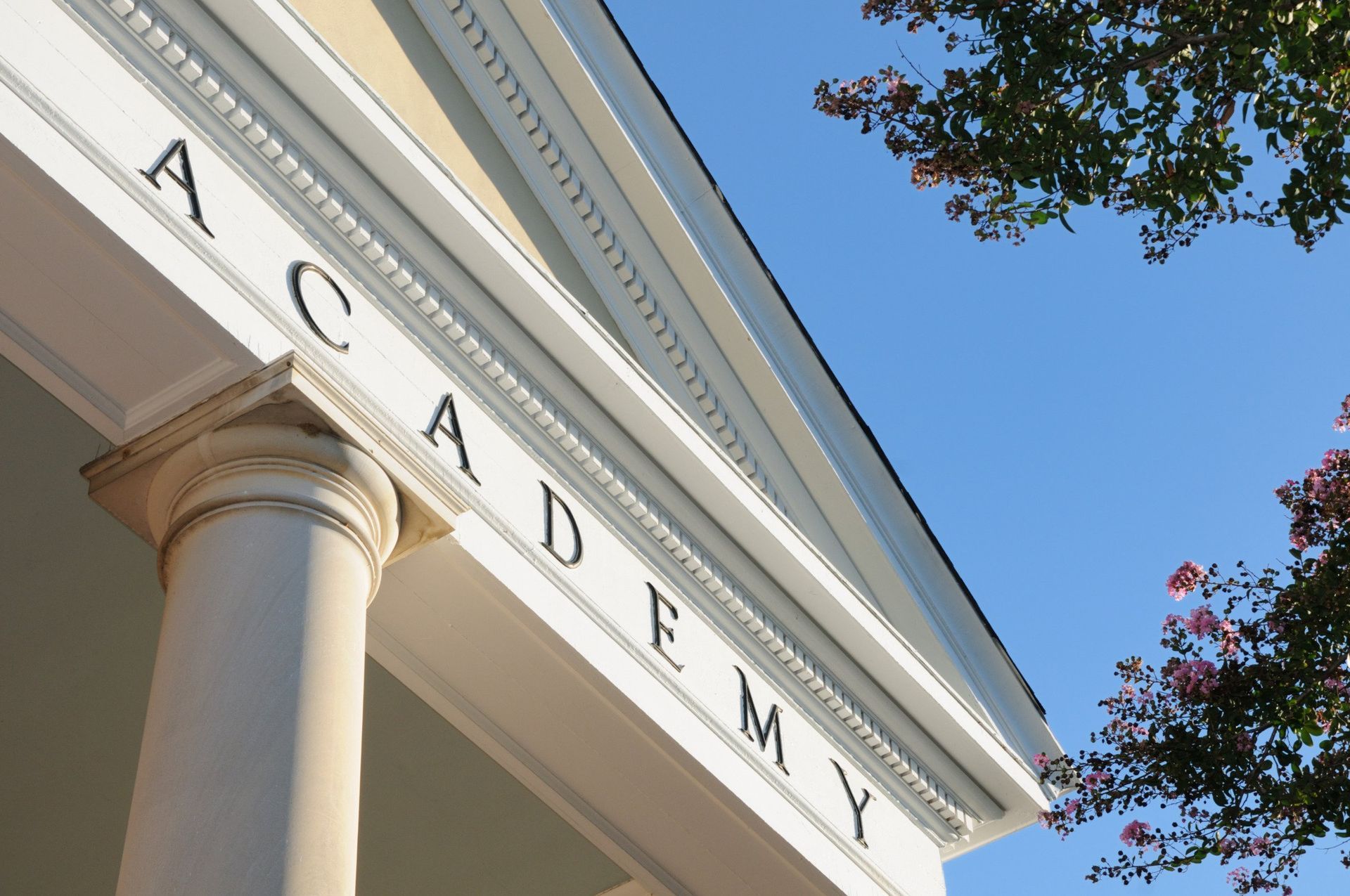 The word academy is on the side of a building