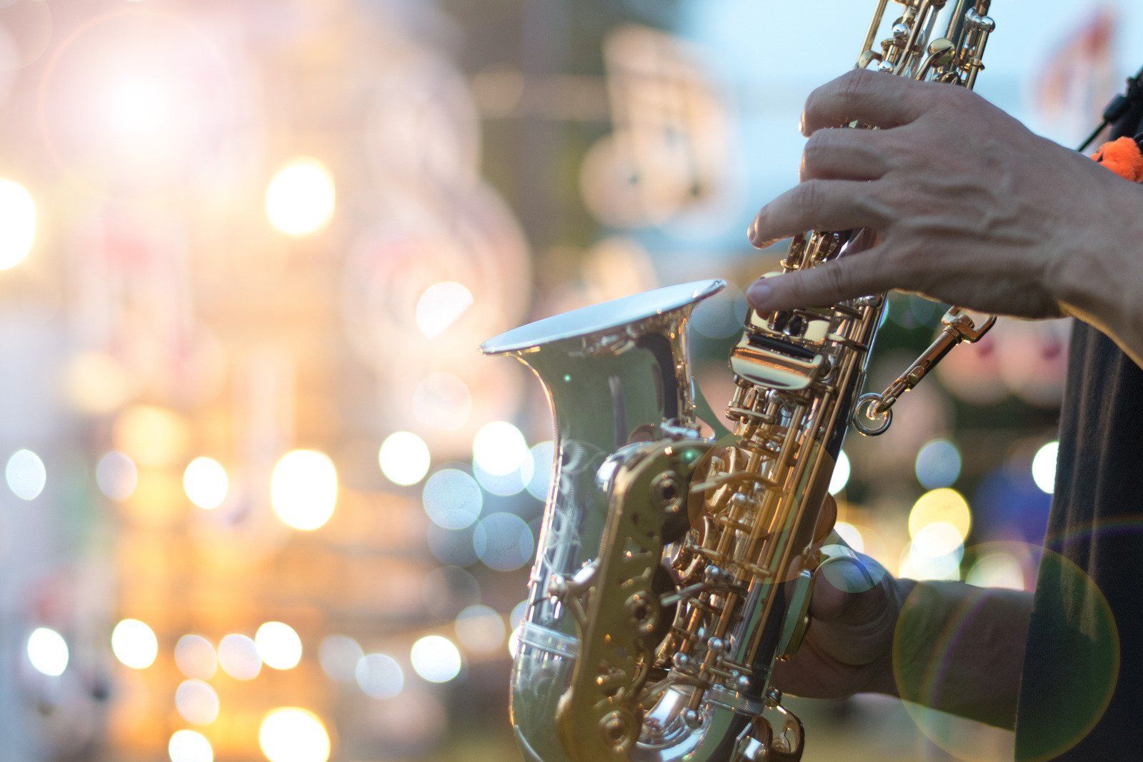 A close up of a person playing a saxophone.