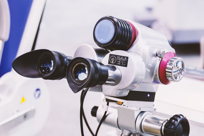 A close up of a microscope on a table.