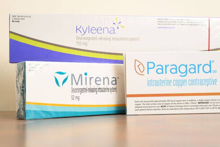 Two boxes of mirena and paragard are sitting on a table.