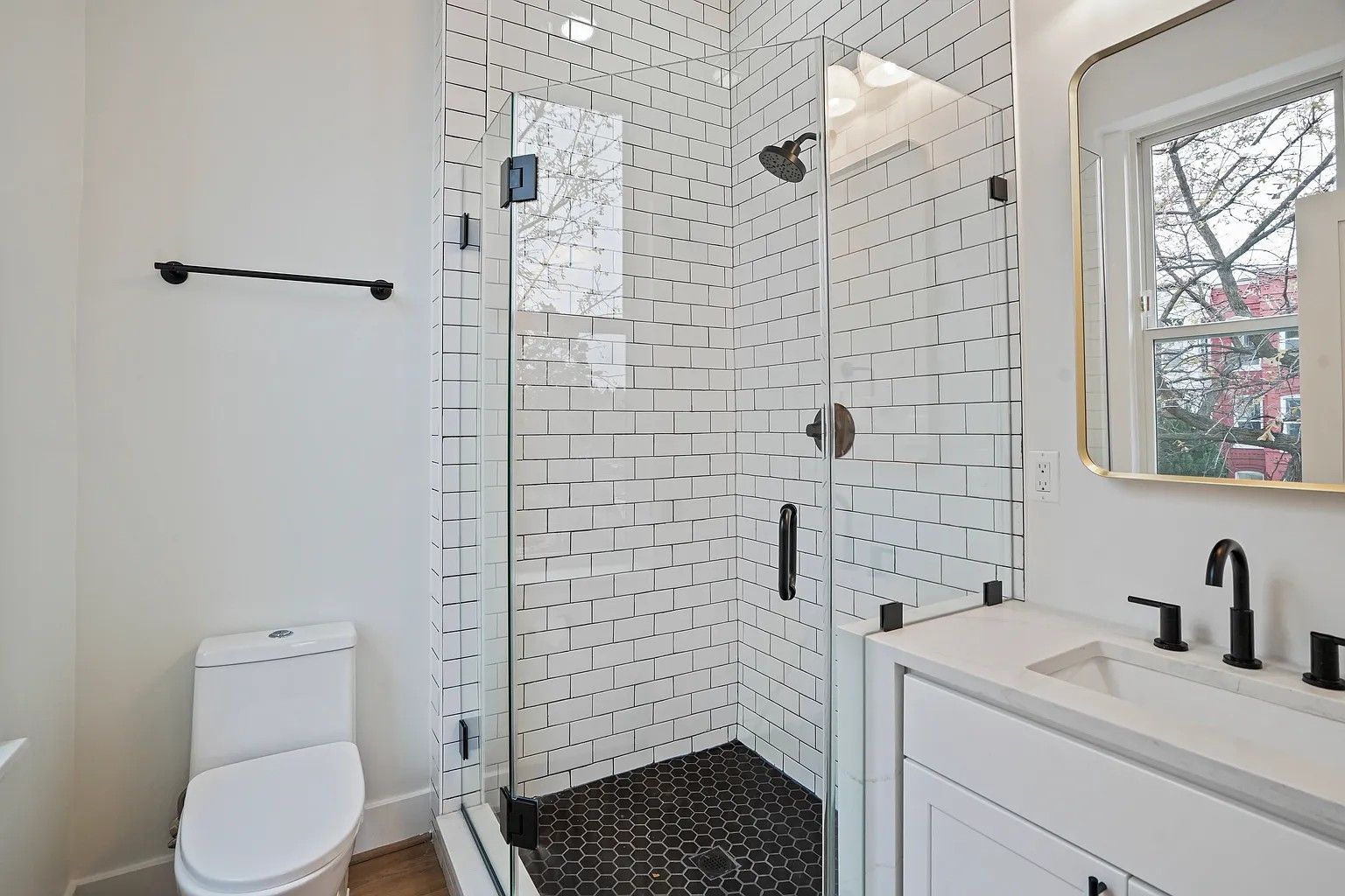 black and white bathroom remodel glass shower subway tile hex floor modern fixtures DC renovation