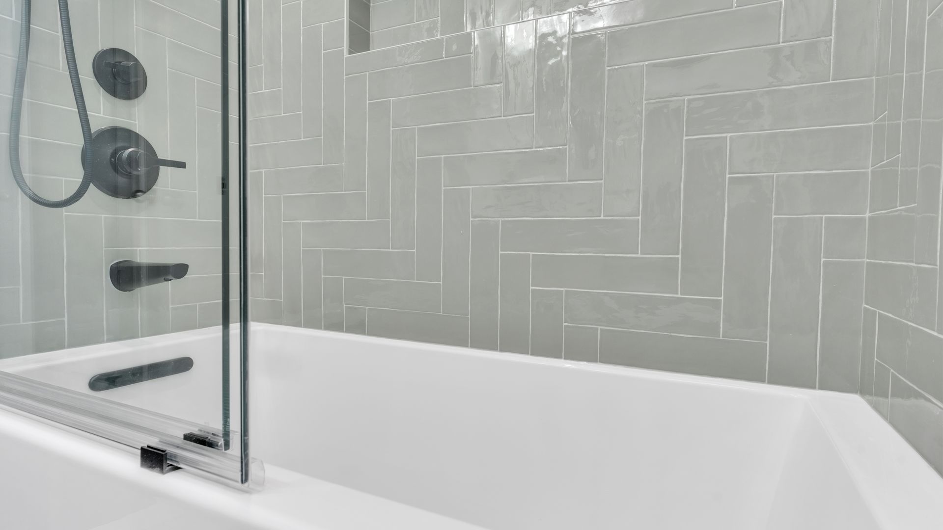 glossy grey tile bathtub shower with black fixtures washington dc bathroom remodel historic home renovation