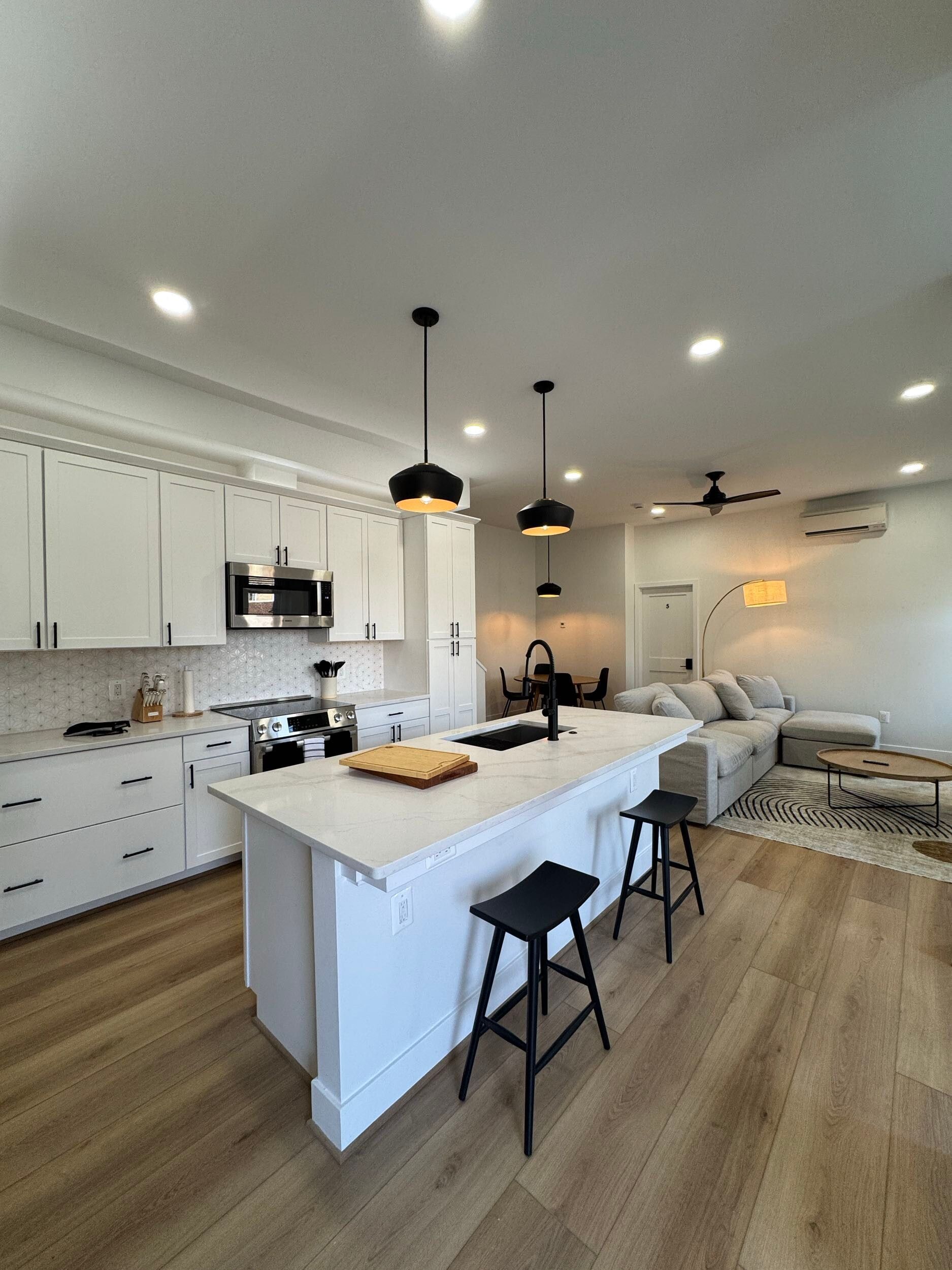 white kitchen open concept island seating quartz counters black hardware DC design build renovation