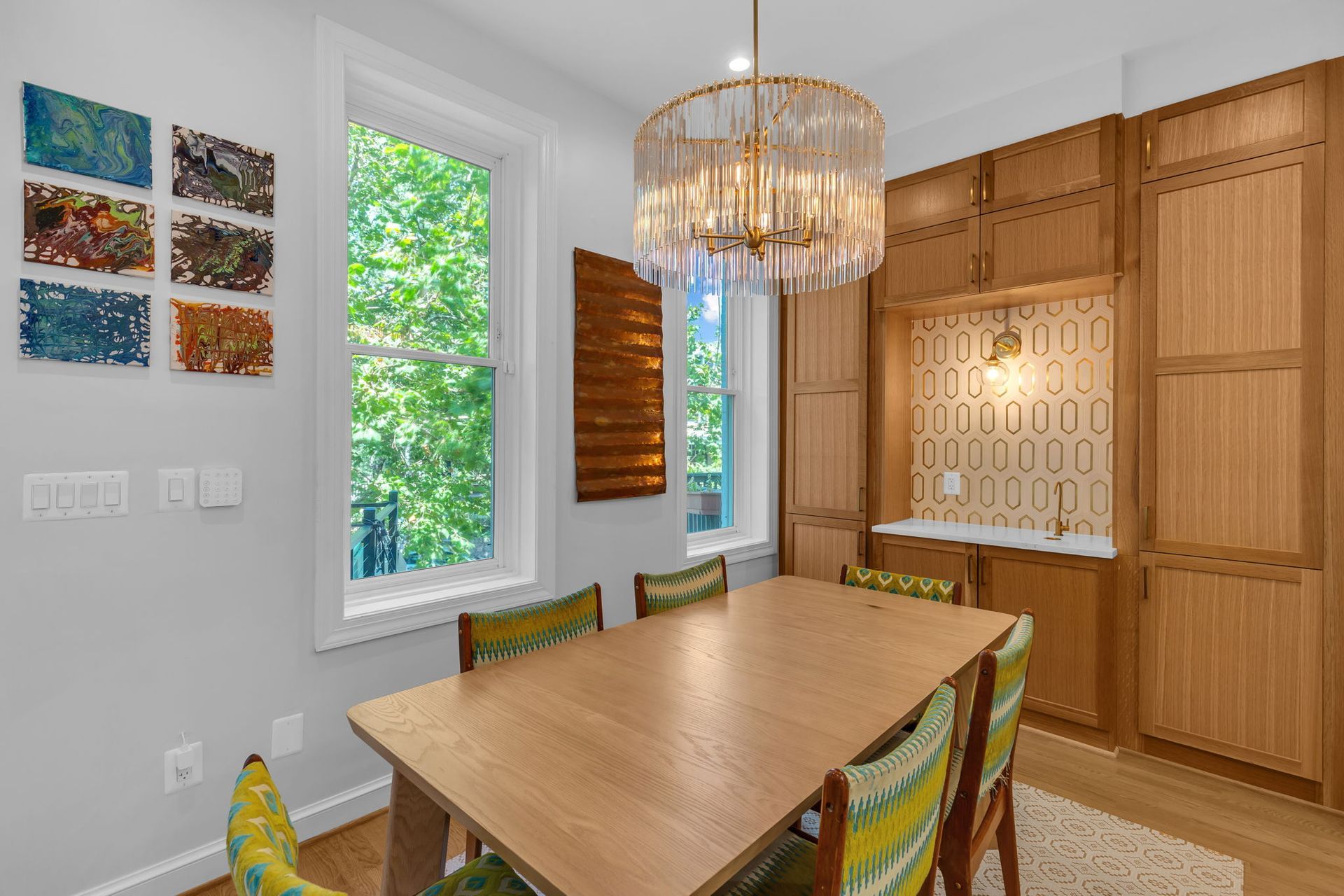 mid-century dining room remodel with built-in wet bar, custom wood cabinetry, and brass chandelier in Washington DC rowhouse