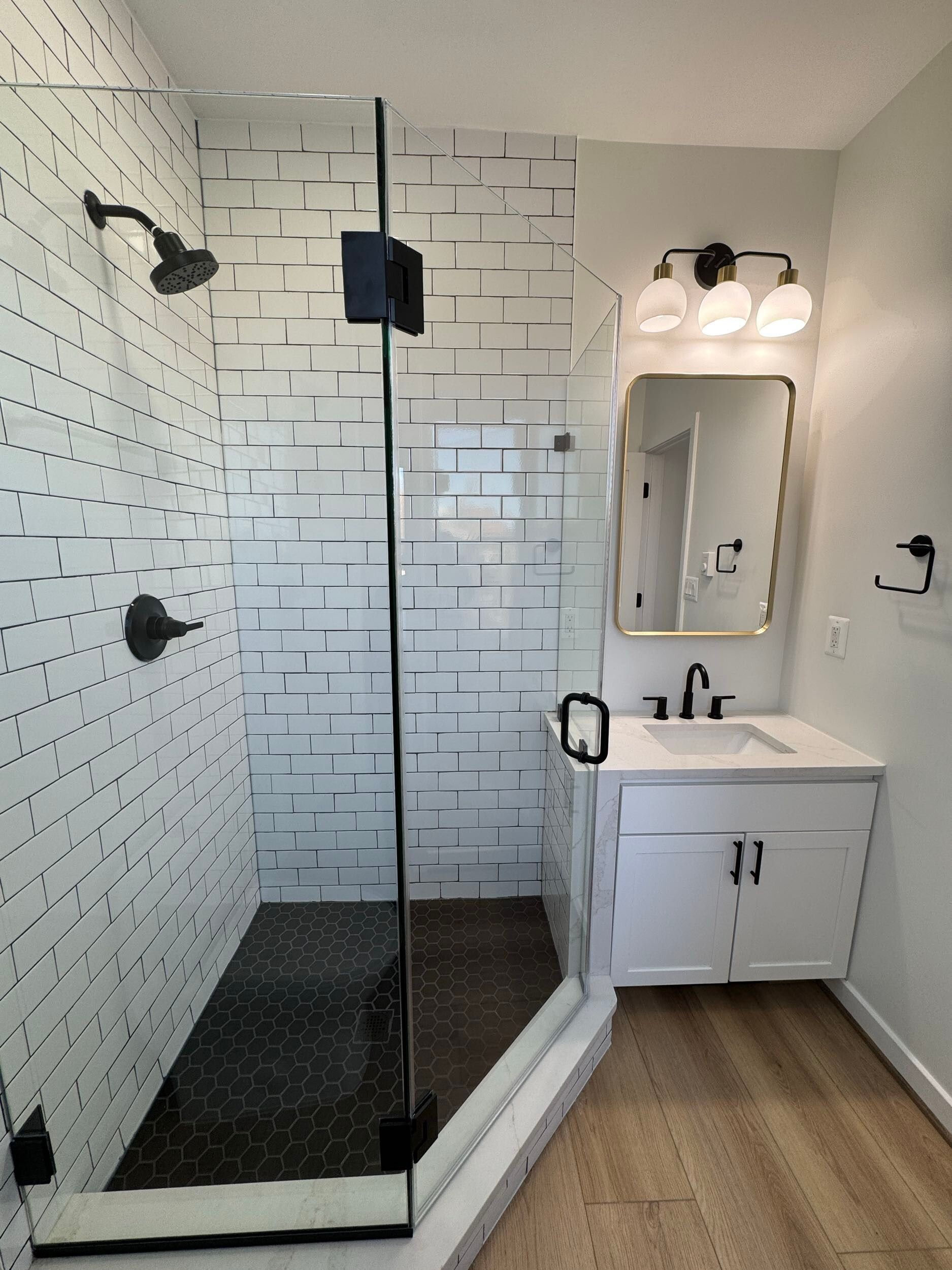 modern bathroom remodel glass shower black fixtures white vanity subway tile floor DC home renovation