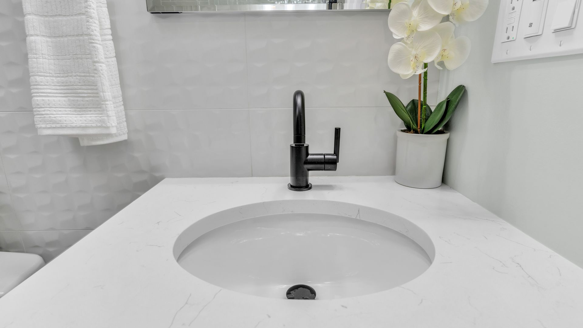 modern bathroom vanity white quartz countertop black faucet textured wall tile DC historic home bathroom remodel