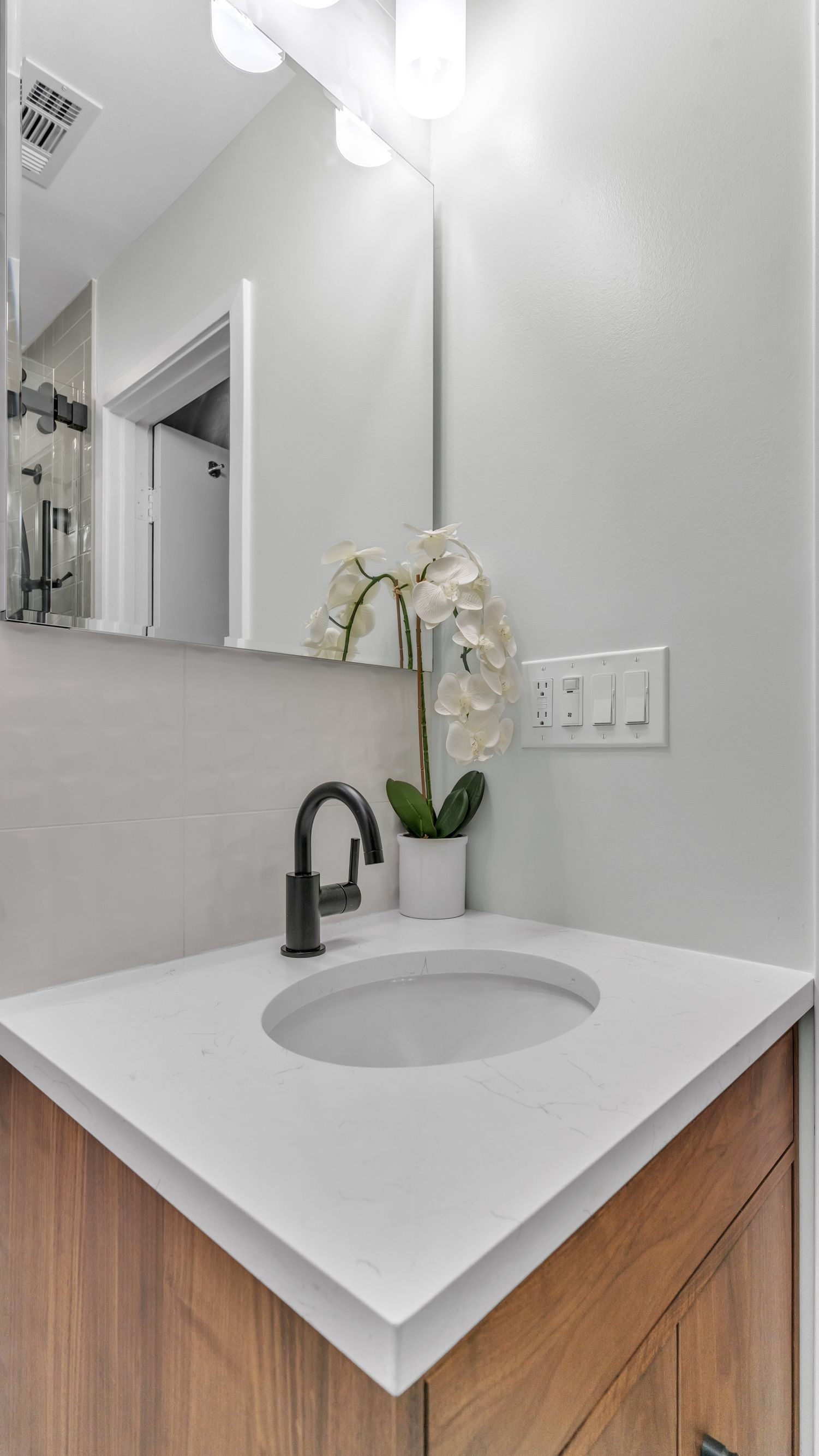 bathroom remodel white quartz vanity black faucet orchid decor modern design