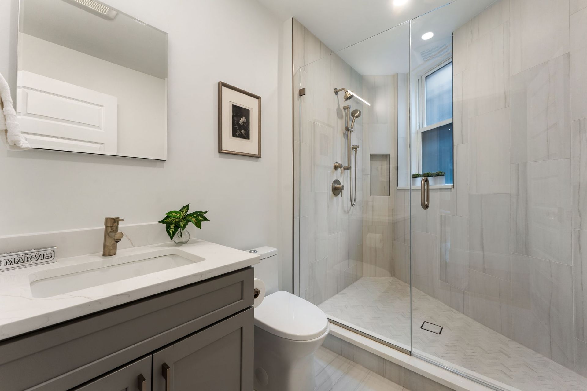 neutral bathroom remodel with glass shower brushed nickel fixtures and custom vanity in historic washington dc home