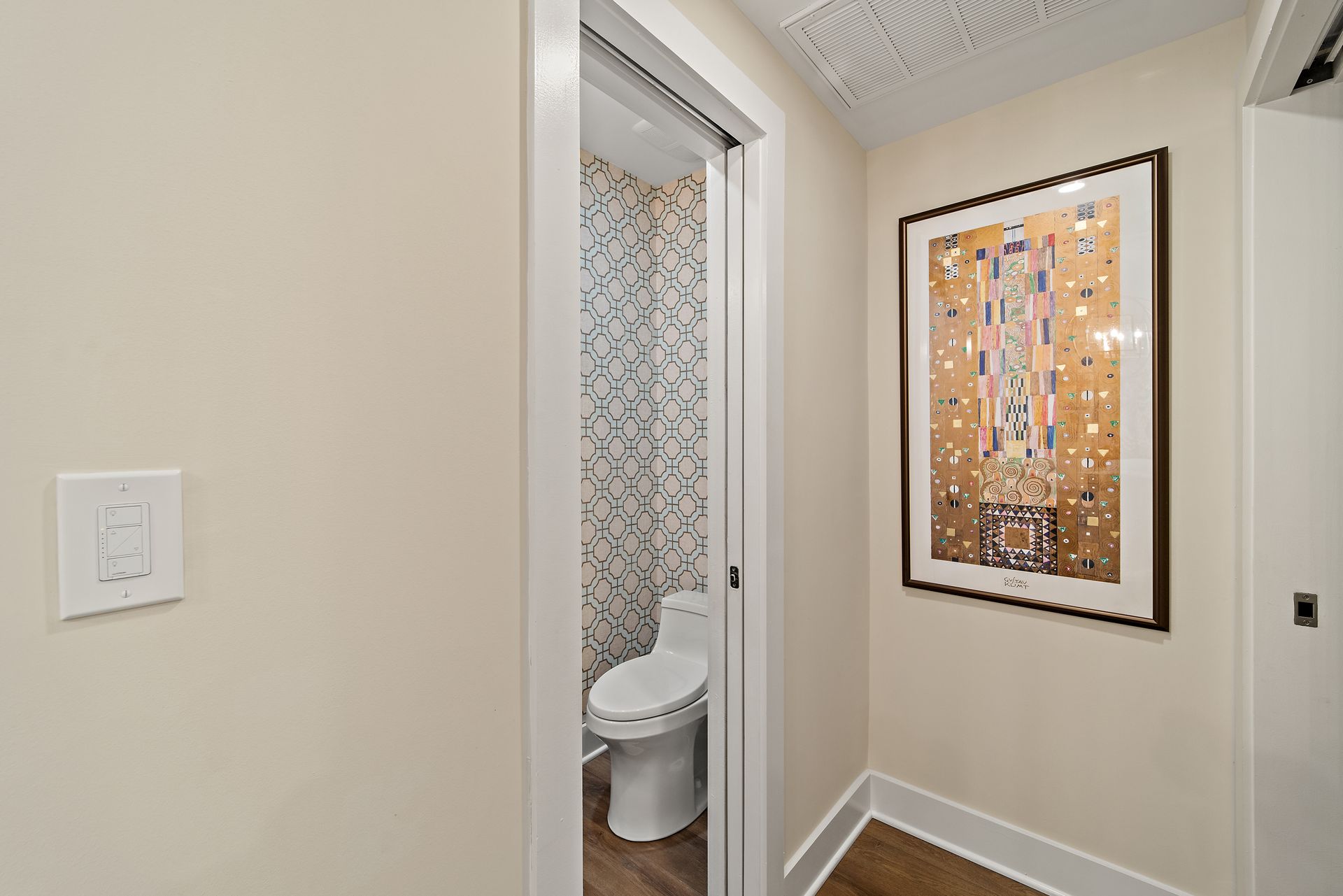 powder room remodel with modern wallpaper and pocket door by washington dc design build firm for older home renovation