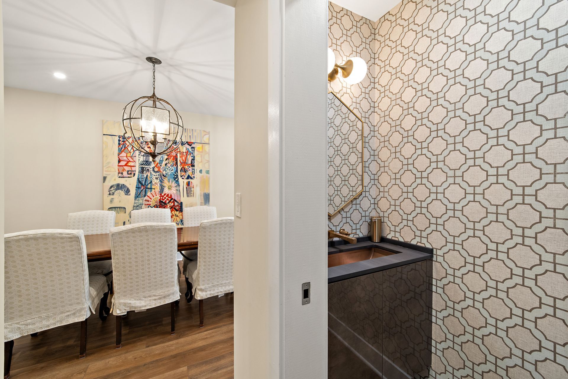 modern powder room with brass faucet, geometric wallpaper, and custom vanity in historic dc home remodel