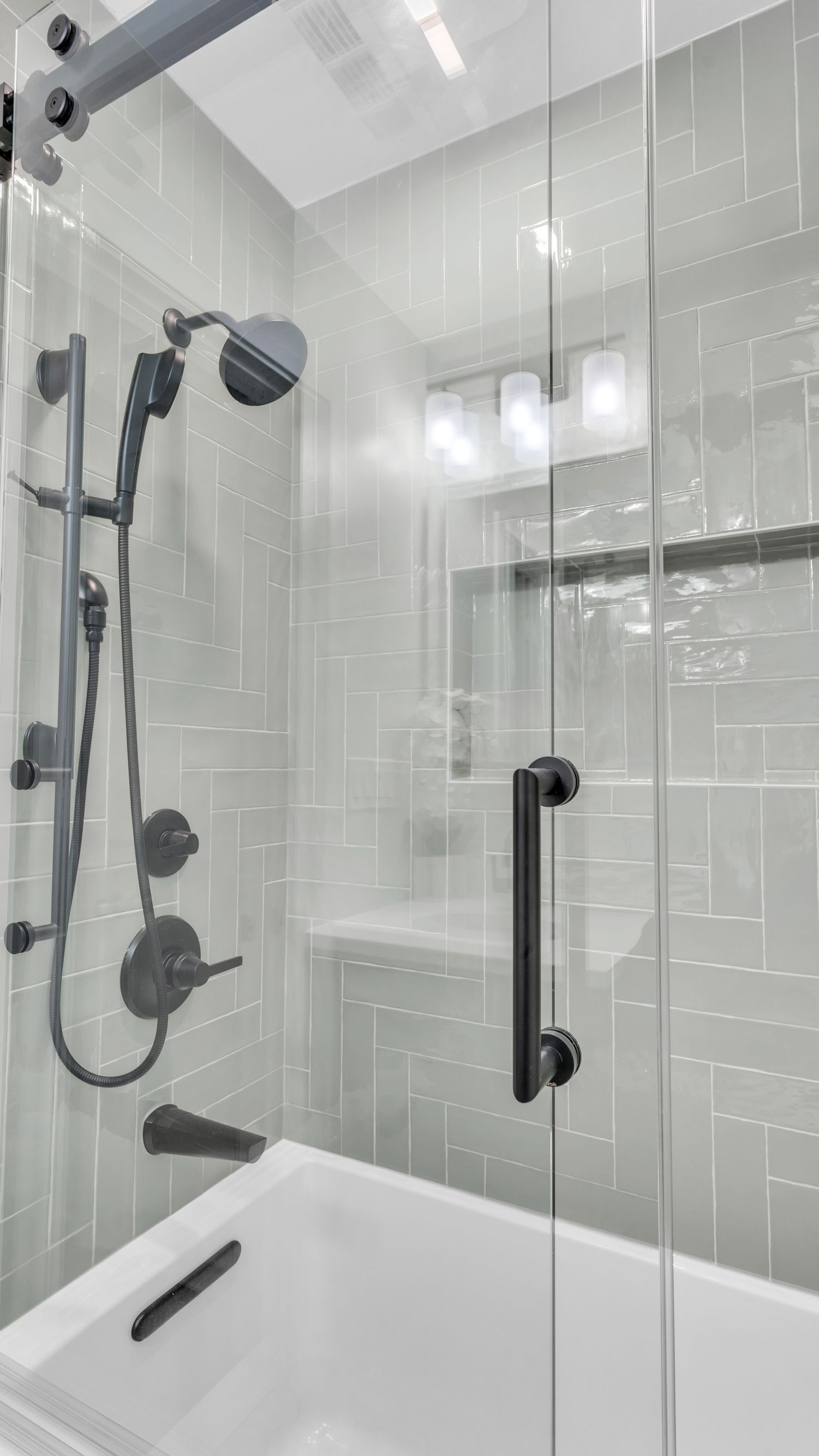 spa-style shower remodel with black fixtures and glass door, Washington DC bathroom renovation design-build
