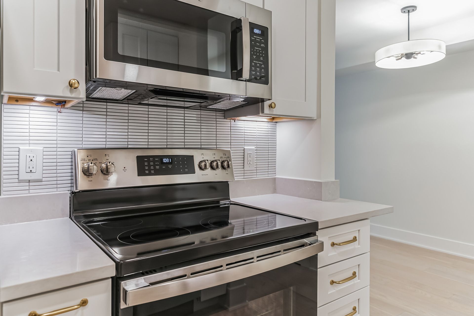 stainless steel oven and microwave with white shaker cabinets gold hardware kitchen remodel ideas