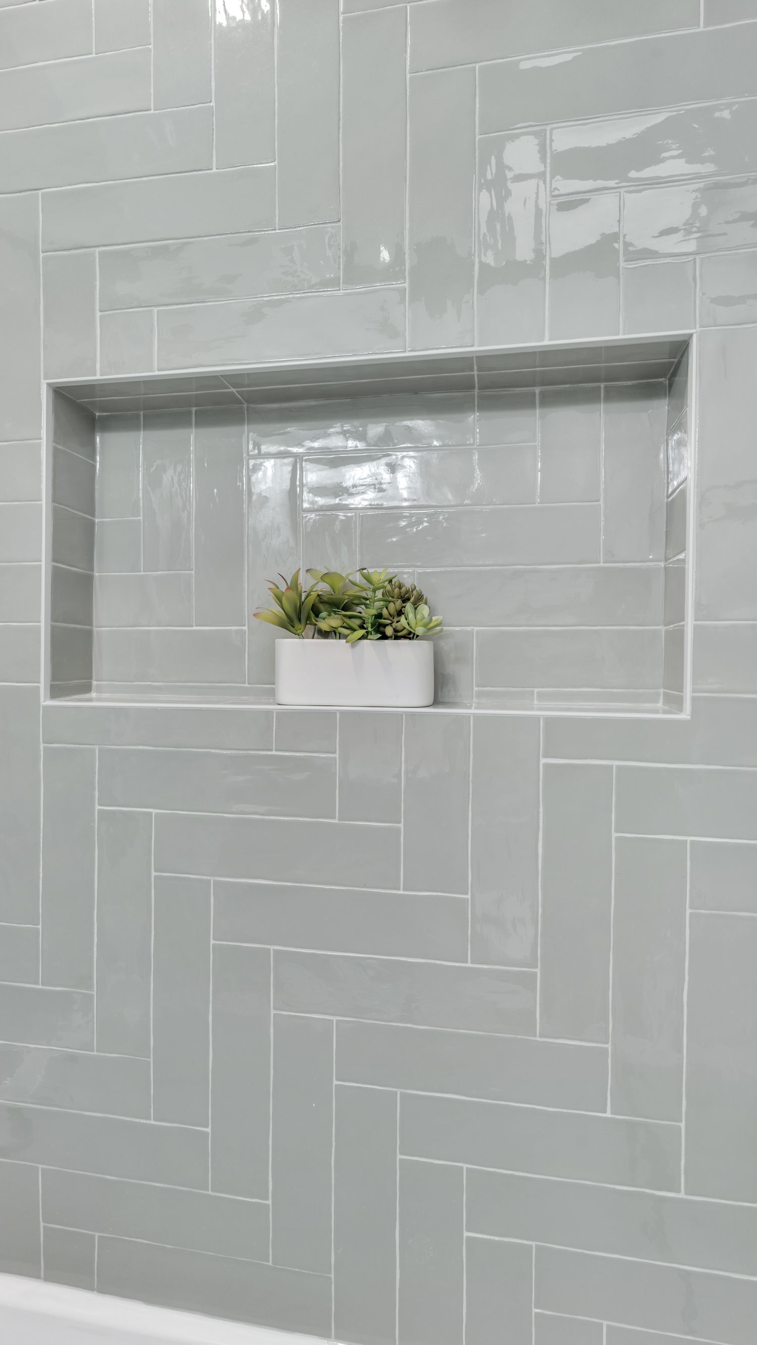 modern bathroom remodel textured tile wall herringbone shower niche light gray glossy tile historic home renovation