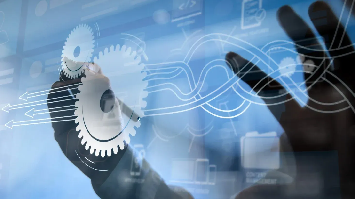 Hands interacting with gears and digital elements.