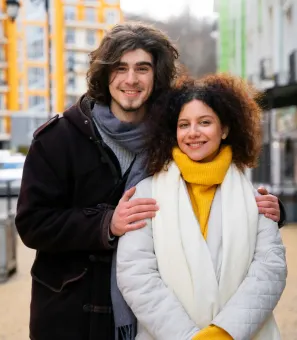 A man and a woman are posing for a picture together