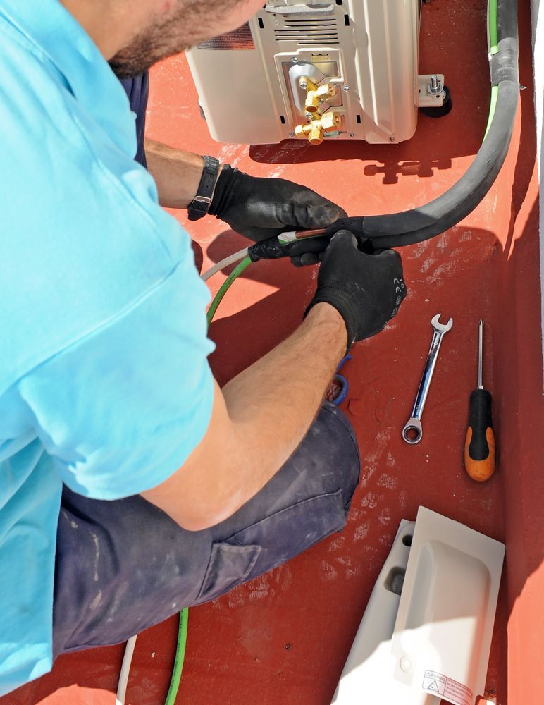 Man In Black Gloves, Working On Hvac Unit, Uses Tools, On A Red Surface — Ace Fridge Door Seals in Mareeba, QLD