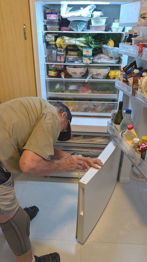 Person on the Floor in Front of an Open Refrigerator — Ace Fridge Door Seals In Cairns, QLD