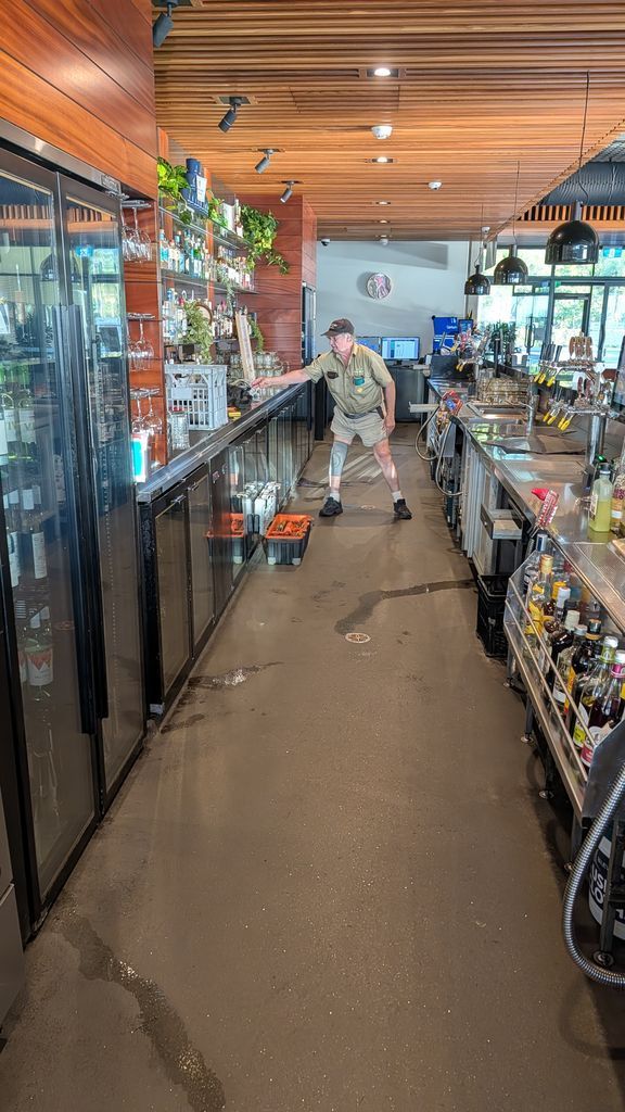 A Person Sweeping the Aisle of a Pet Store With Fish Tanks and Shelves — Ace Fridge Door Seals In Cairns, QLD